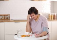 woman-measures-blood-pressure-with-a-headache-because-of-lack-of-vitamin-B12