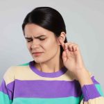 woman-experiencing-ear-pain-with-worried-expression