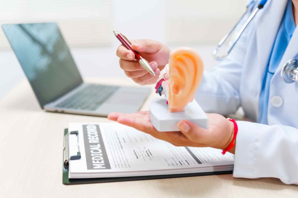 doctor-explains-ear-anatomy-with-model-in-office-Acute-otitis-media