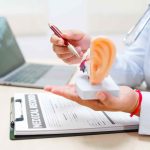 doctor-explains-ear-anatomy-with-model-in-office-Acute-otitis-media